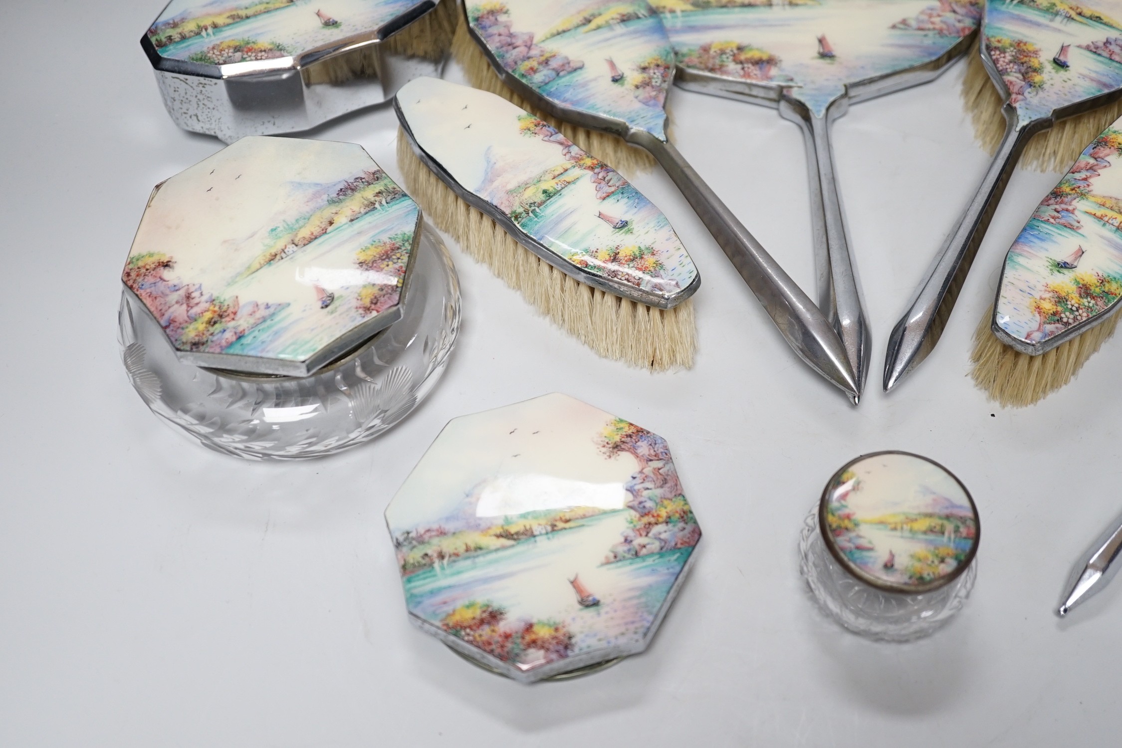 A twelve piece chrome plated and enamel dressing table set